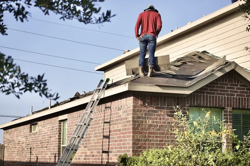 Professional roofer working on a residential roof in Riva Farms